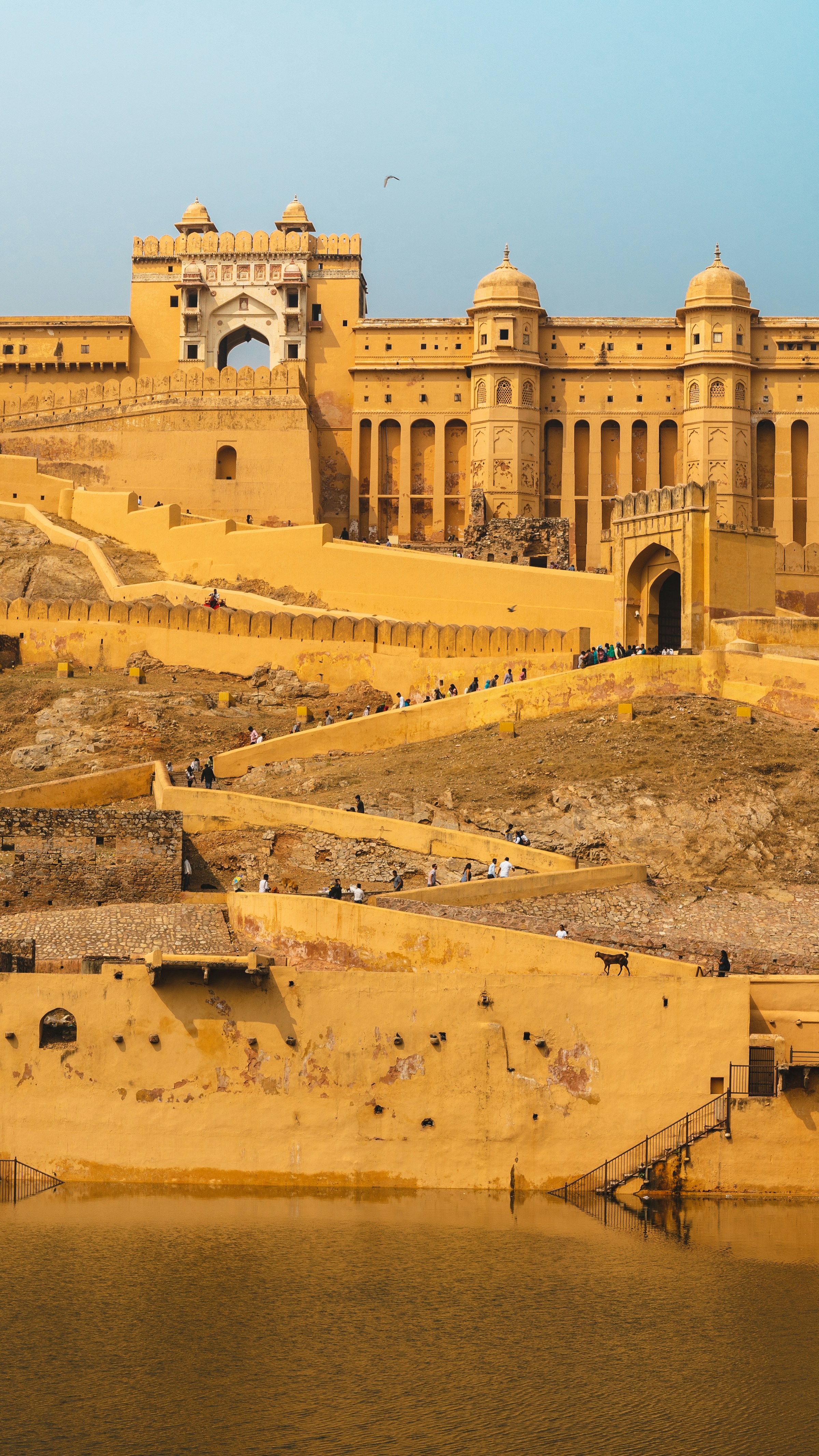 Scenic view of Amber Fort in Jaipur reflected in the lake at golden hour